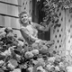 CIRCA 1950s: Woman outside of home, nr hydrangea bush. (Photo by George Marks/Retrofile/Getty Images)